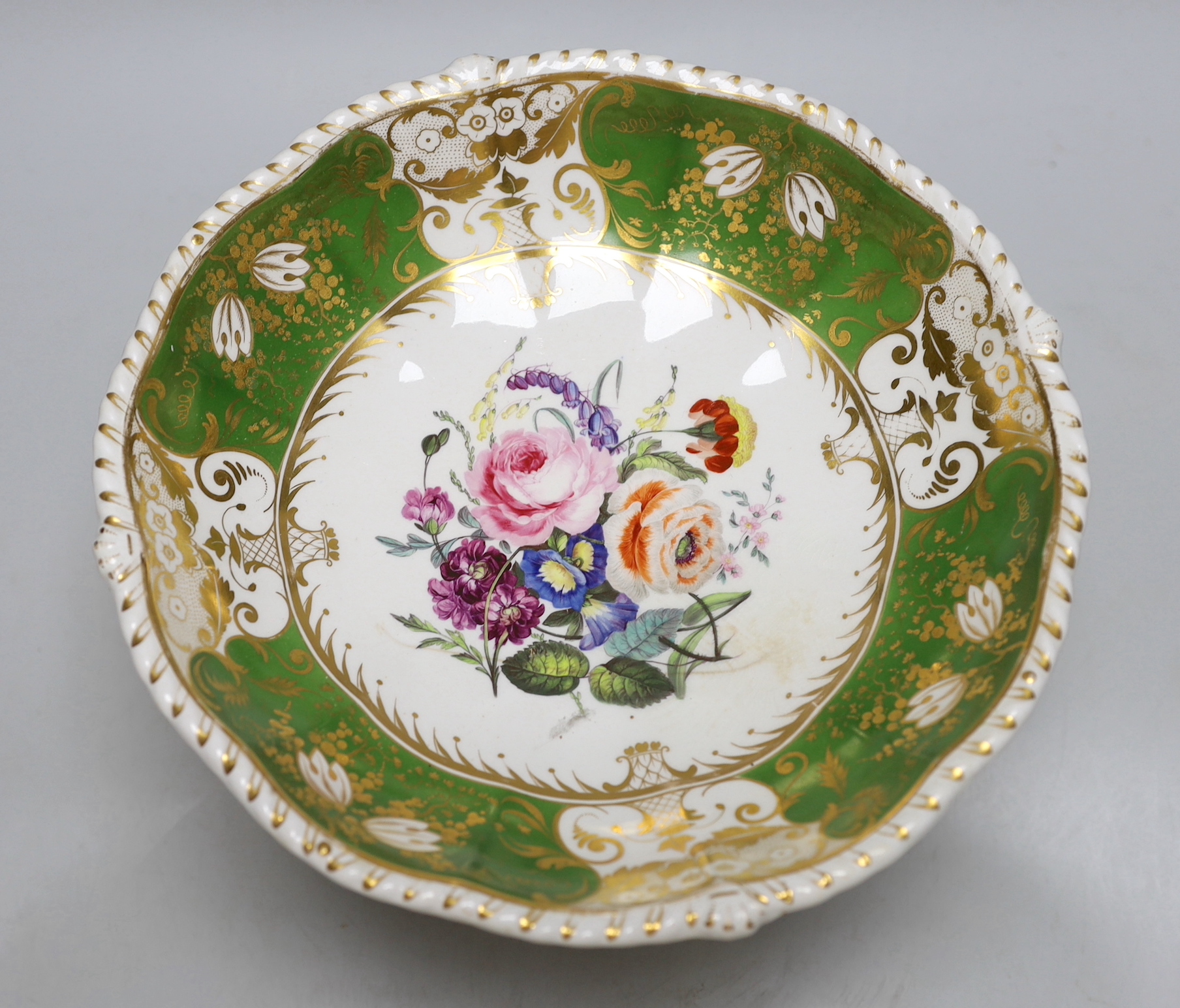 A Derby three footed comport, the centre painted with flowers, the border with green ground having four white gilded panels and four green gilded panels, c.1825, 17cm high